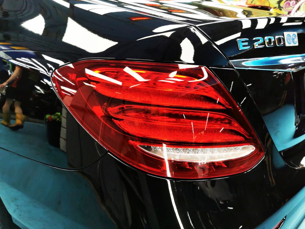 The coated bonnet of the E200 under workshop lighting.
