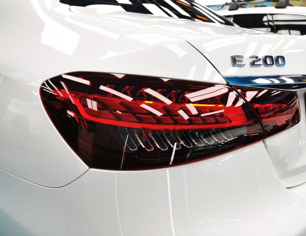 The coated bonnet of the E200 under workshop lighting.