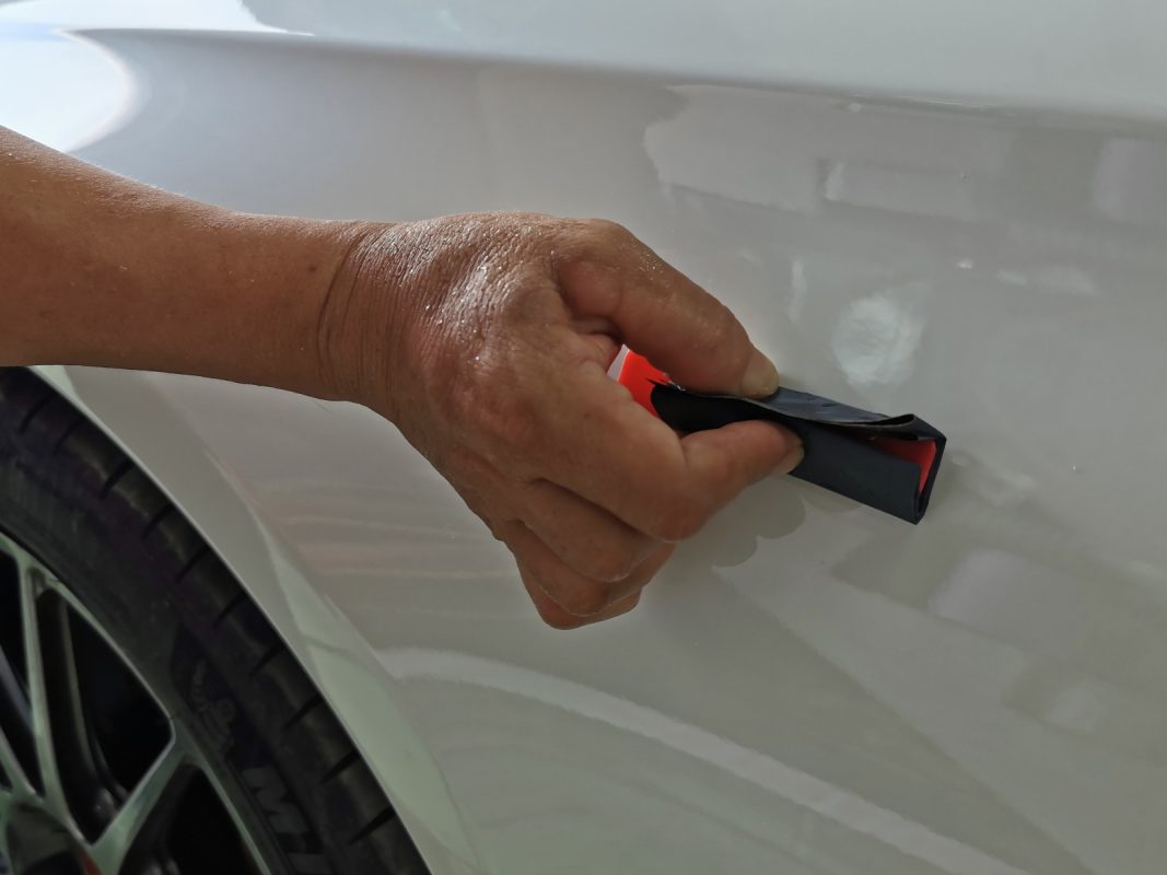 The E200 being touched up after spraying for an even surface.