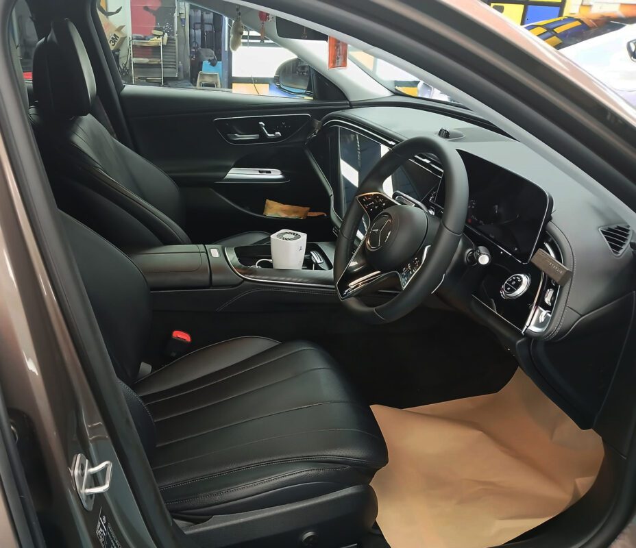 The Mercedes-Benz E200 parked in the workshop, freshly coated.