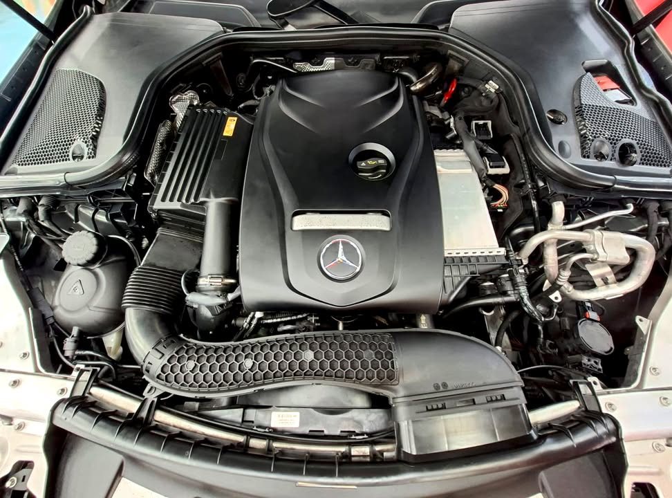 Engine bay of the Mercedes-Benz E200 with the engine cover in view.