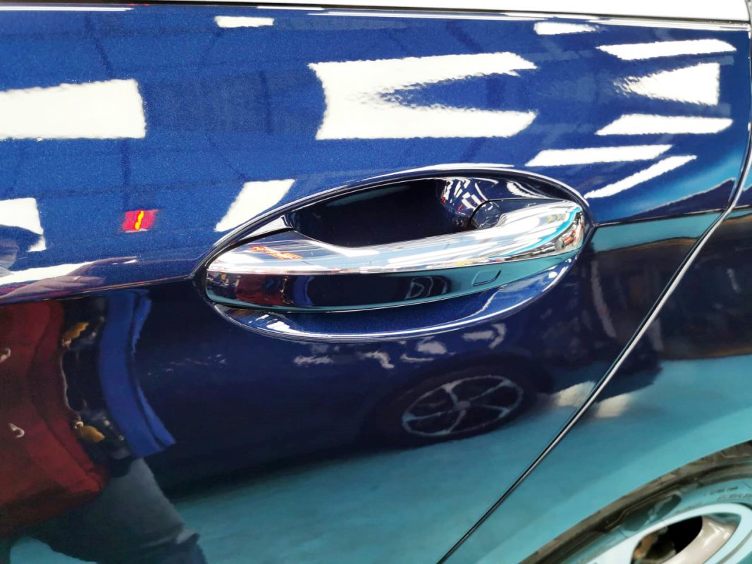 Rear quarter of the Mercedes-Benz E200K, glossy and protected.