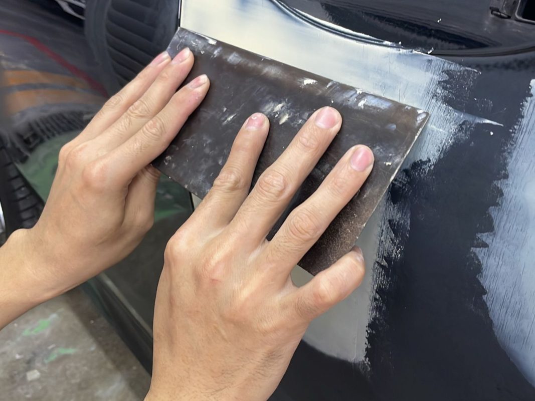 The car's surface inspected and patched where the paintwork was imperfect.