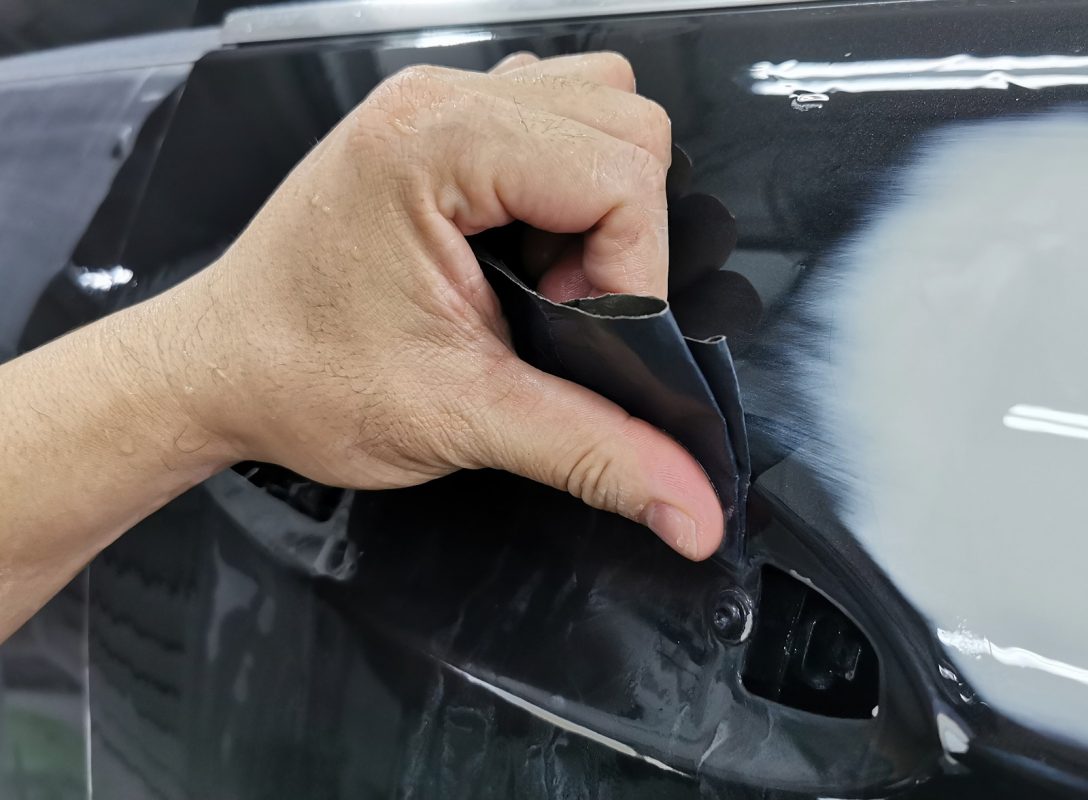 Wet-sanding the E250's panels to smooth the existing paintwork.