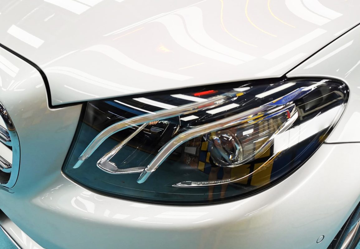 The E250's coated paintwork showing clean reflections.