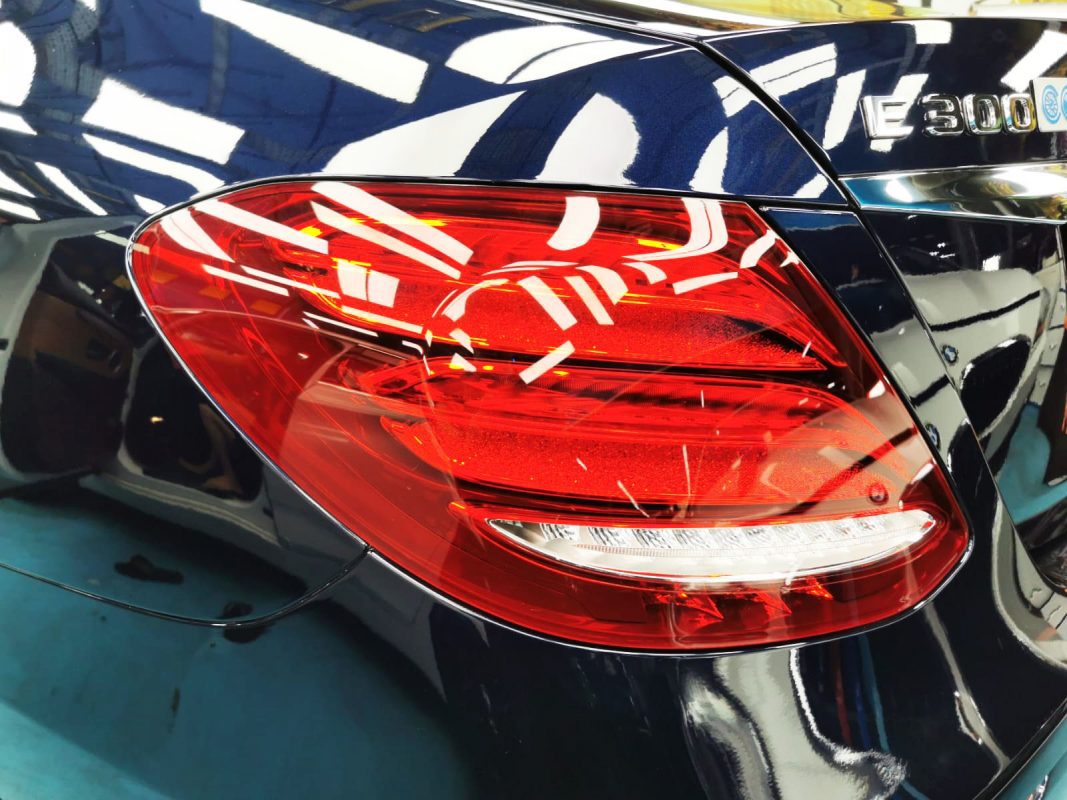 The coated bonnet of the E300 under workshop lighting.