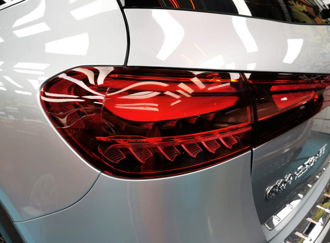 The coated bonnet of the Mercedes-Benz EQA250+ under workshop lighting.