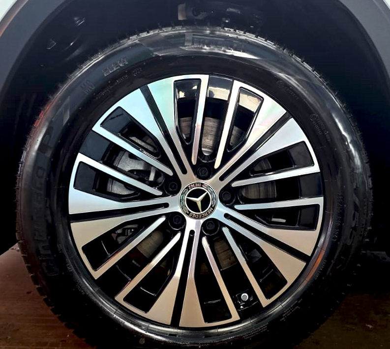 The coated bonnet of the Mercedes-Benz EQB 250+ under workshop lighting.