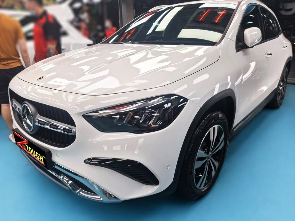 White Mercedes-Benz GLA 180 from the front three-quarter in the workshop after the ZeTough Ceramic coating.