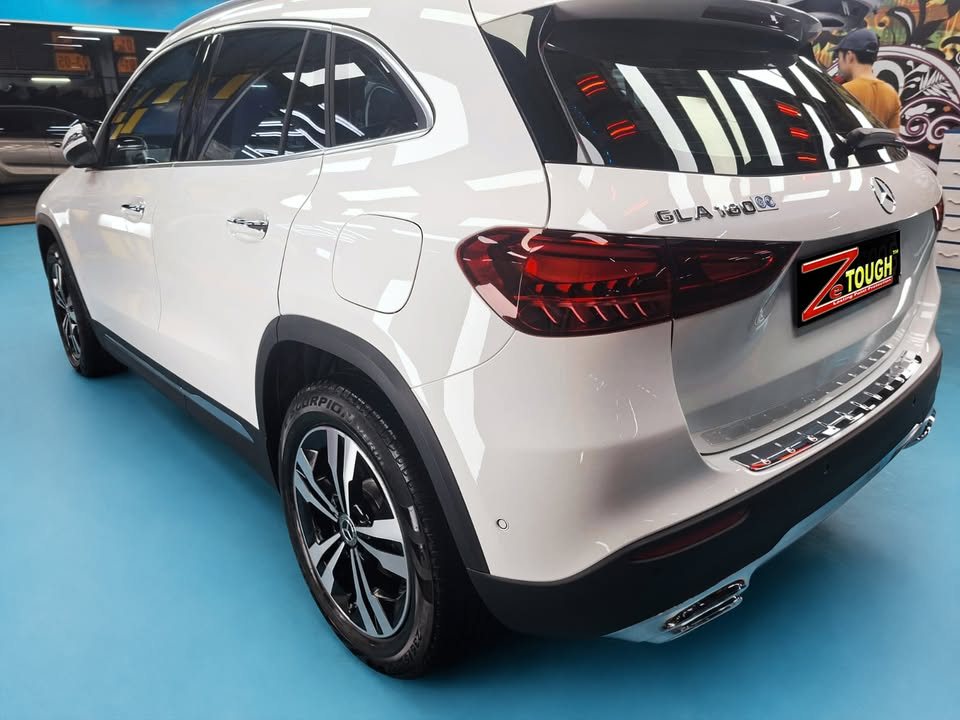 Rear three-quarter view of the white Mercedes-Benz GLA 180.