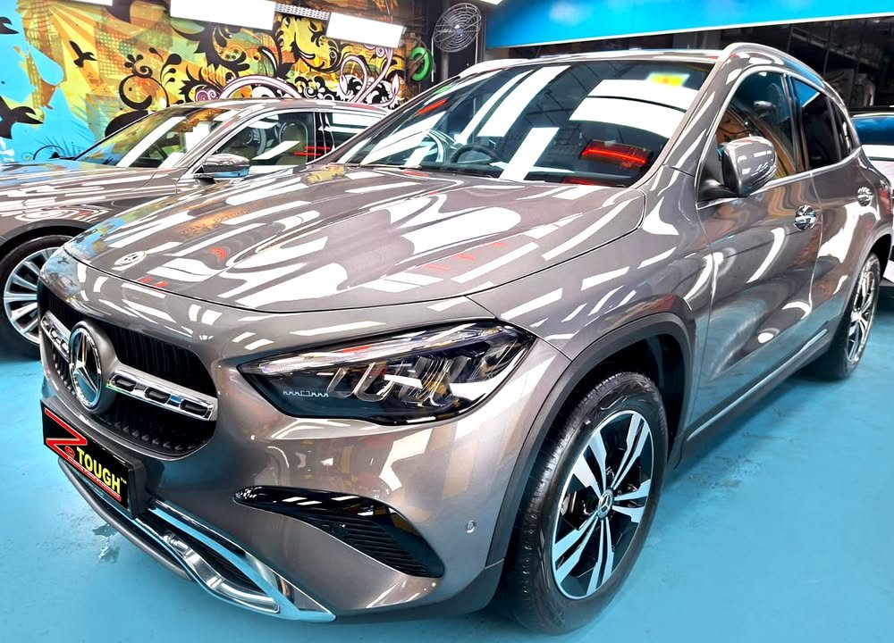 Front three-quarter view of a grey Mercedes-Benz GLA 180 in the Revol Carz hall after coating.