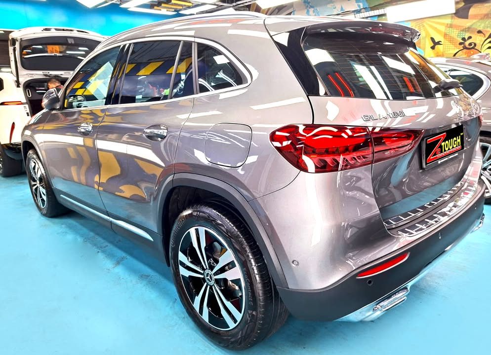 Rear three-quarter view of the grey Mercedes-Benz GLA 180 showing the tail lights.