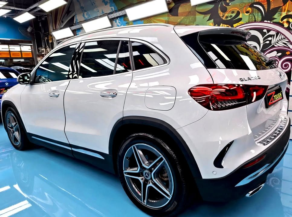 Rear three-quarter view of the white GLA 200 in the workshop.