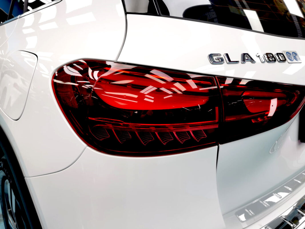 The coated bonnet of the Mercedes-Benz GLA180 under workshop lighting.