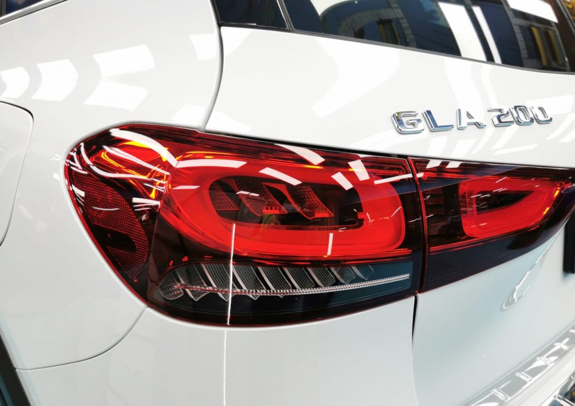 The coated bonnet of the GLA200 AMG under workshop lighting.