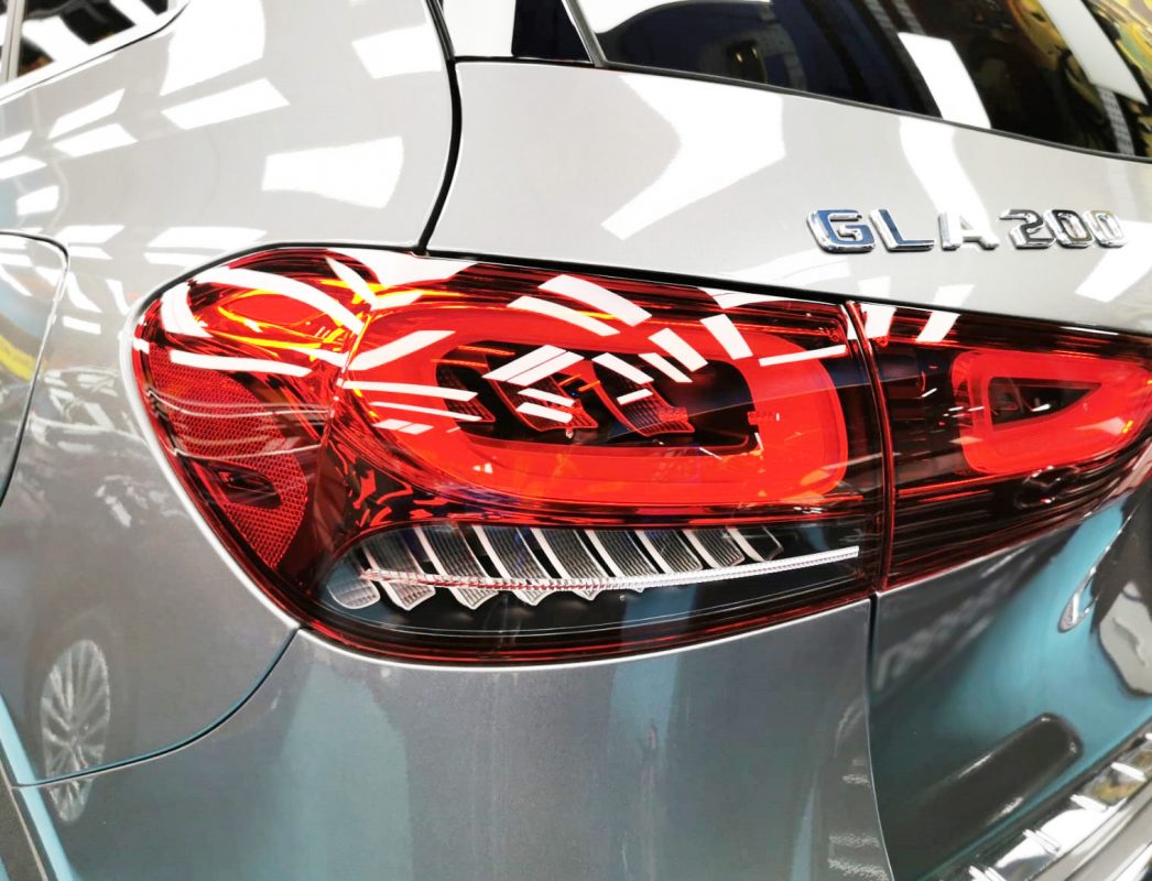 The coated bonnet of the Mercedes-Benz GLA200 under workshop lighting.