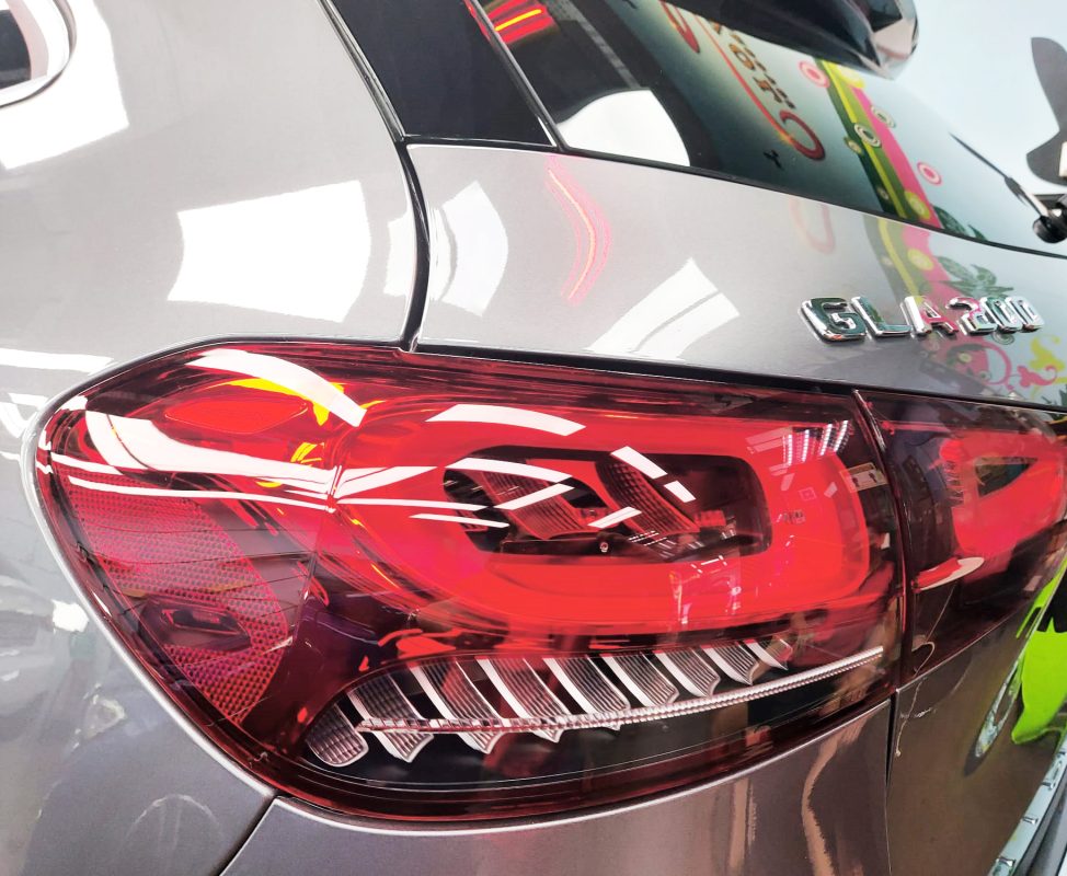 The coated bonnet of the Mercedes-Benz GLA200 under workshop lighting.