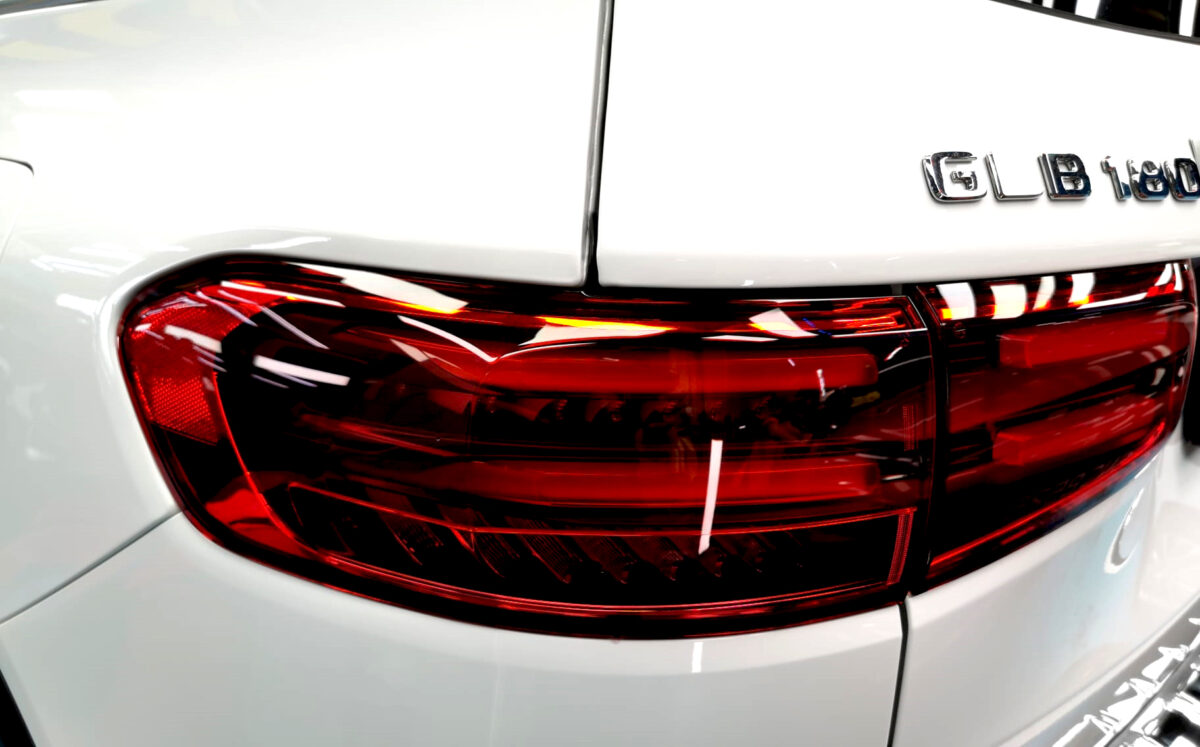The coated bonnet of the Mercedes-Benz GLB180 under workshop lighting.