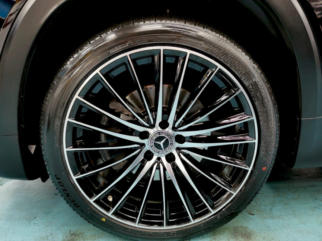The coated bonnet of the Mercedes-Benz GLB200 under workshop lighting.