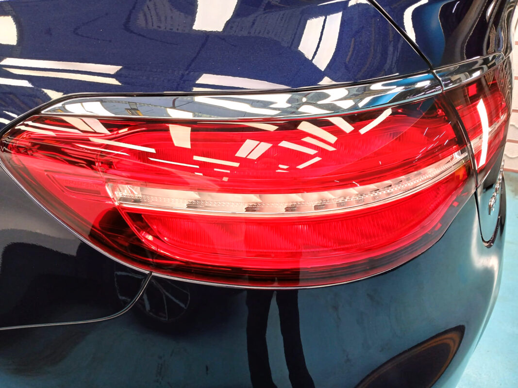 The coated bonnet of the Mercedes-Benz GLC 250 under workshop lighting.