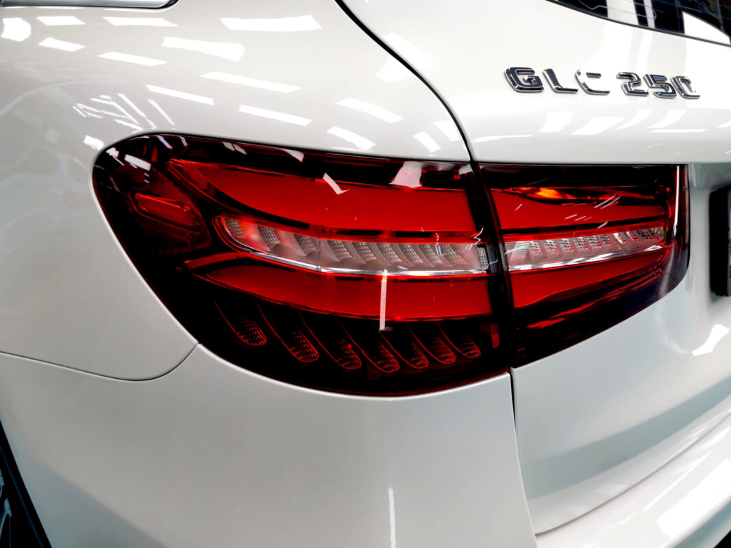 The coated bonnet of the Mercedes-Benz GLC 250 under workshop lighting.