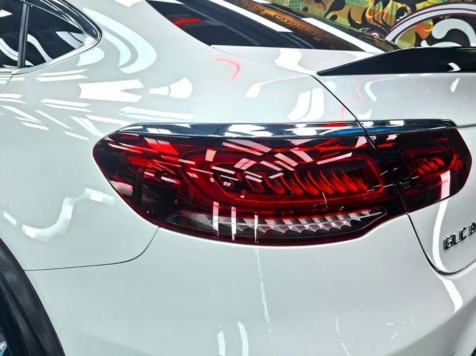 Close-up of the red tail light on the white rear quarter.