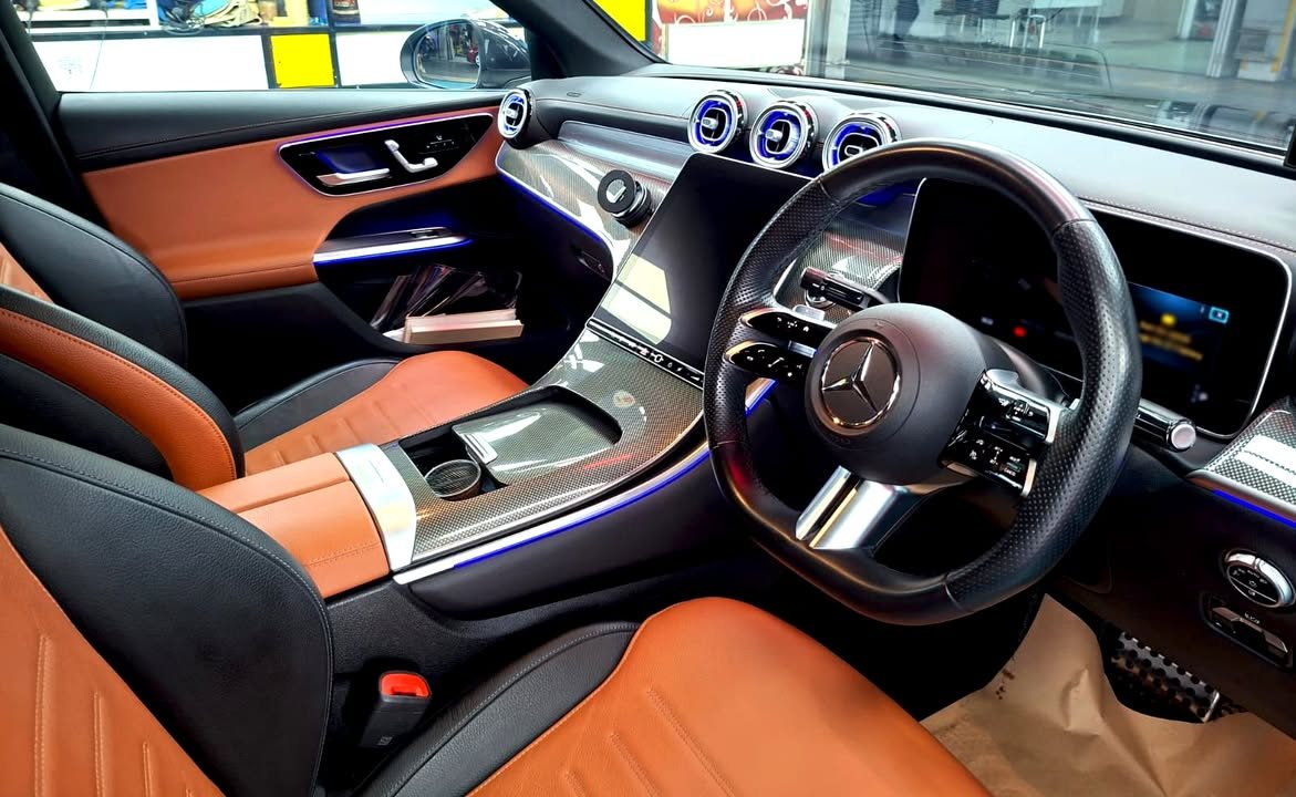 Interior with tan and black leather seats, steering wheel and centre console.