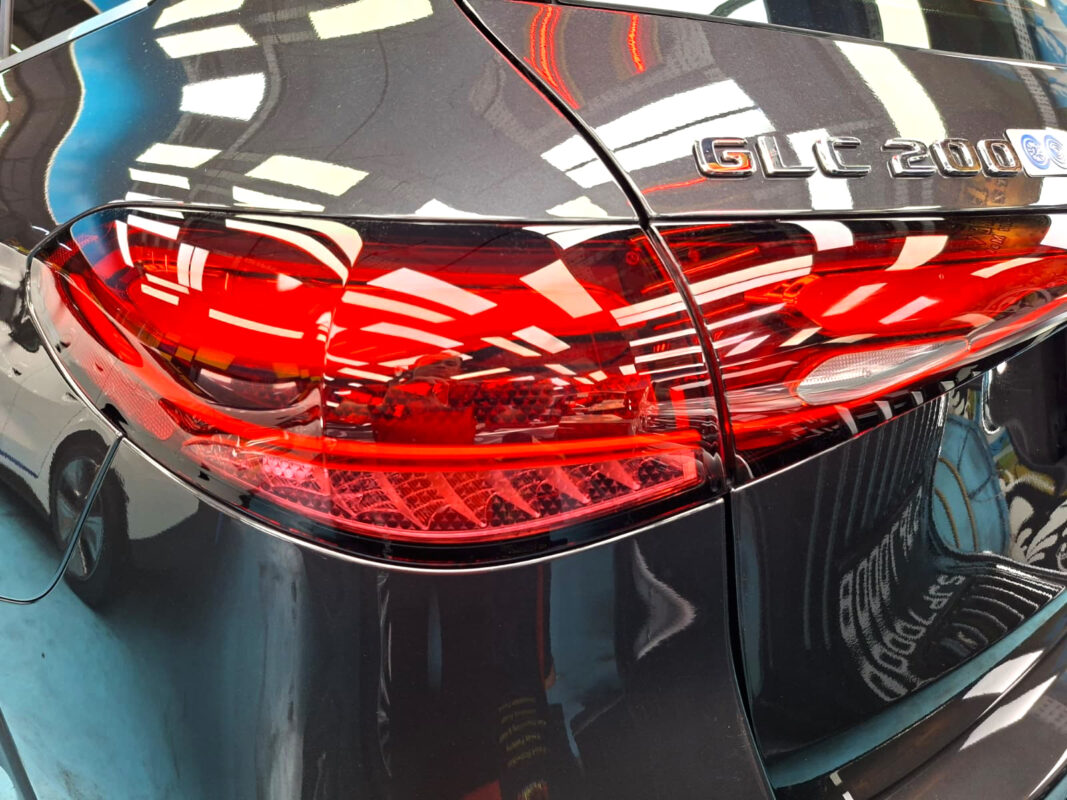 The coated bonnet of the Mercedes-Benz GLC200 under workshop lighting.