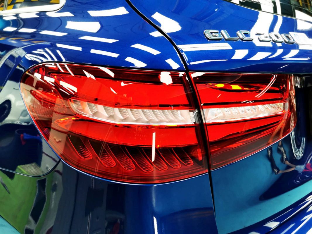 The coated bonnet of the Mercedes-Benz GLC200 under workshop lighting.