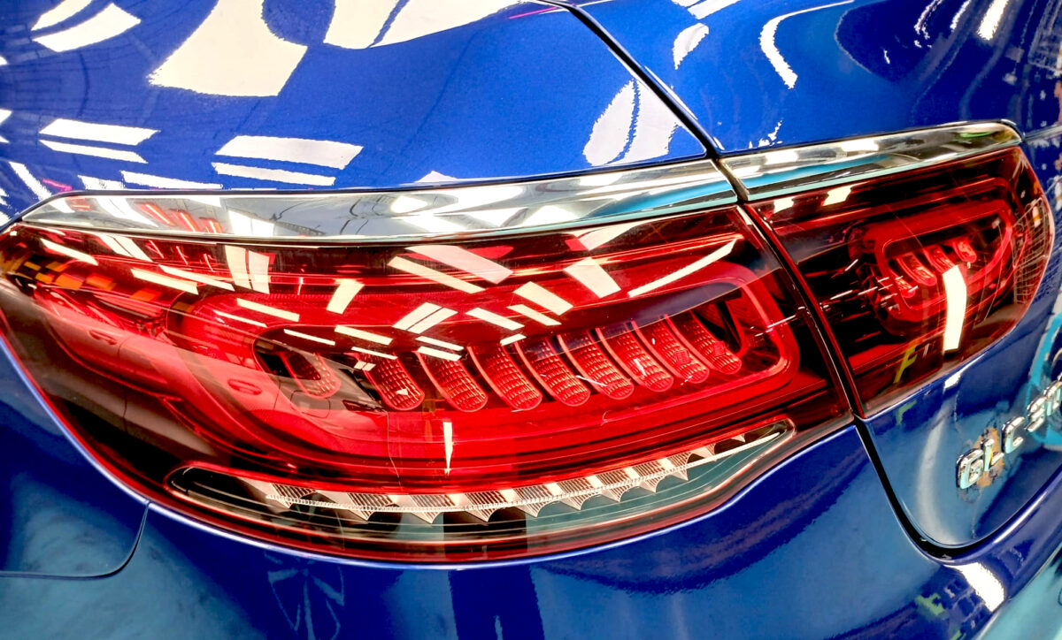 The coated bonnet of the Mercedes-Benz GLC300 under workshop lighting.
