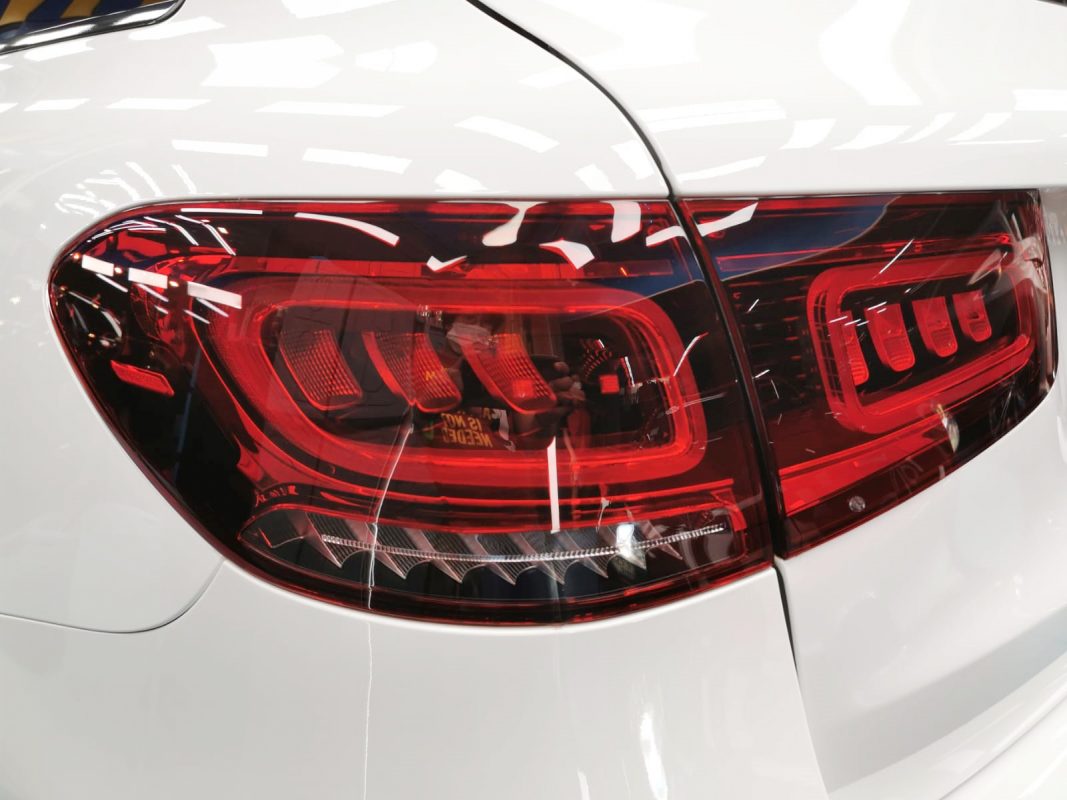 The coated bonnet of the Mercedes-Benz GLC300 under workshop lighting.