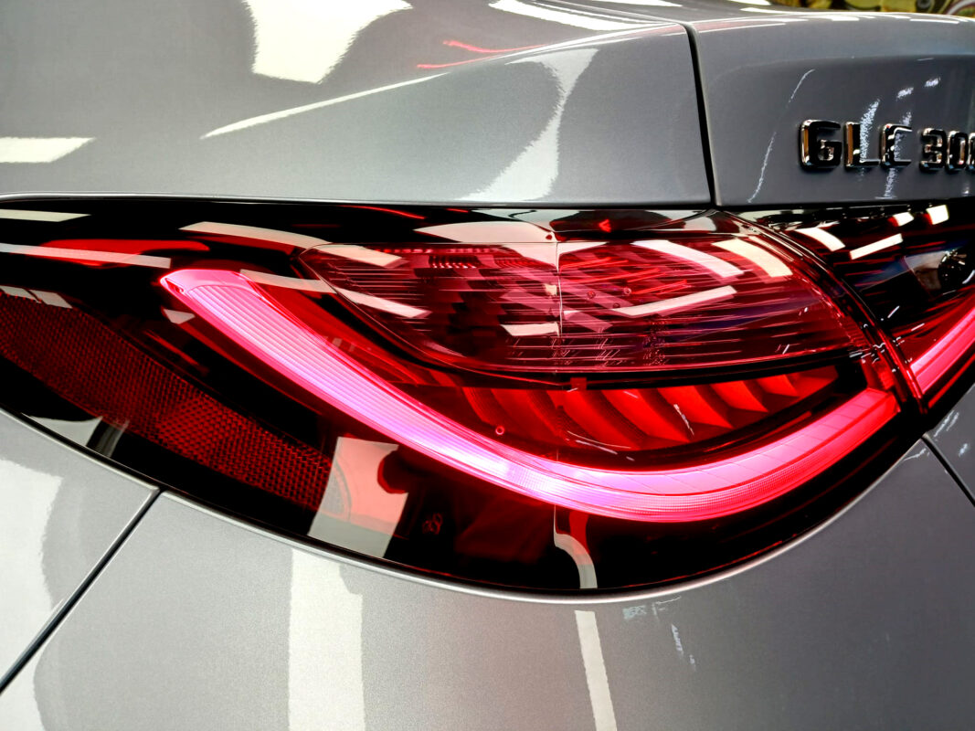 The coated bonnet of the Mercedes-Benz GLC300 under workshop lighting.