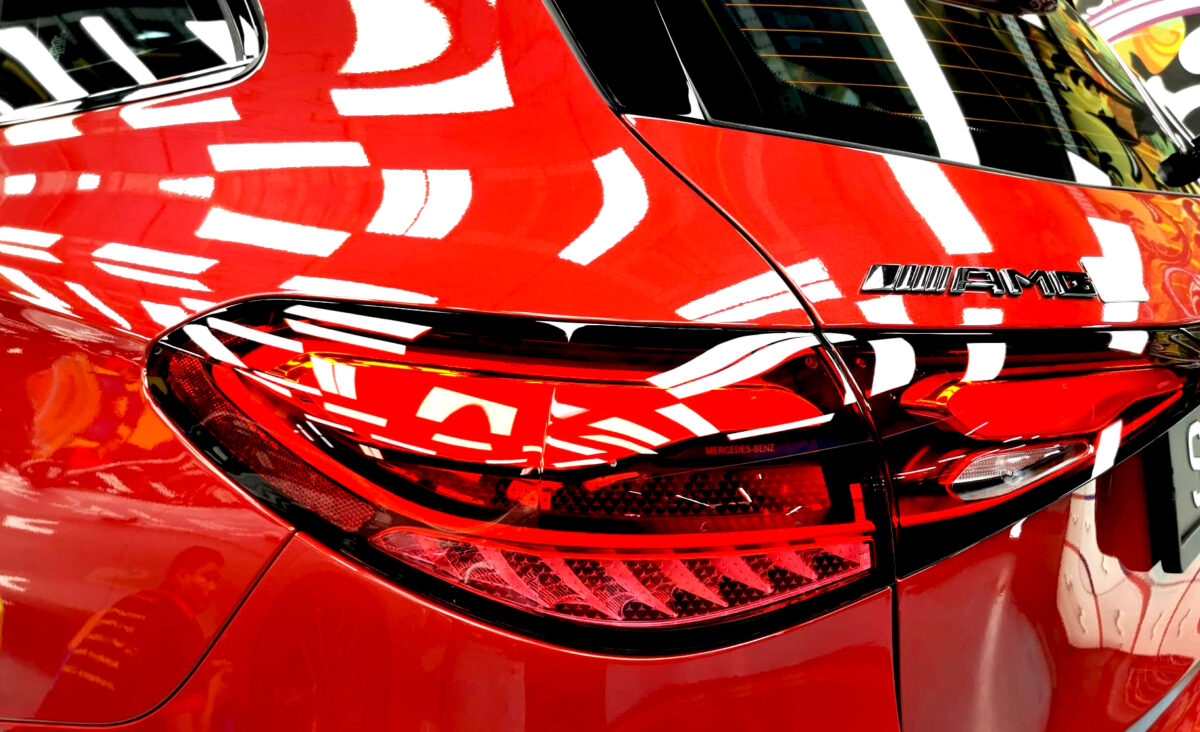 The coated bonnet of the Mercedes-Benz GLC43 under workshop lighting.