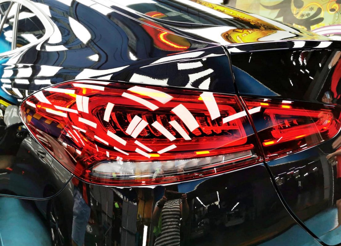 The coated bonnet of the Mercedes-Benz GLE450 under workshop lighting.