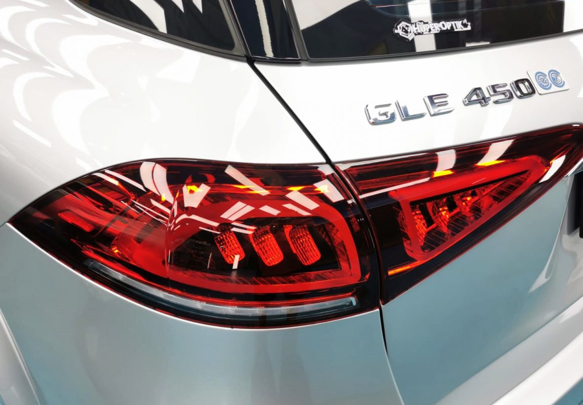 The coated bonnet of the Mercedes-Benz GLE450 under workshop lighting.