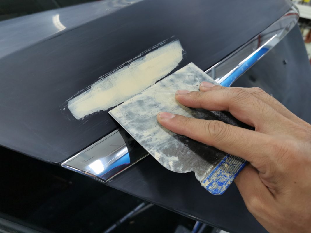 The body of the Mercedes-Benz S320L being examined and patched for imperfections.