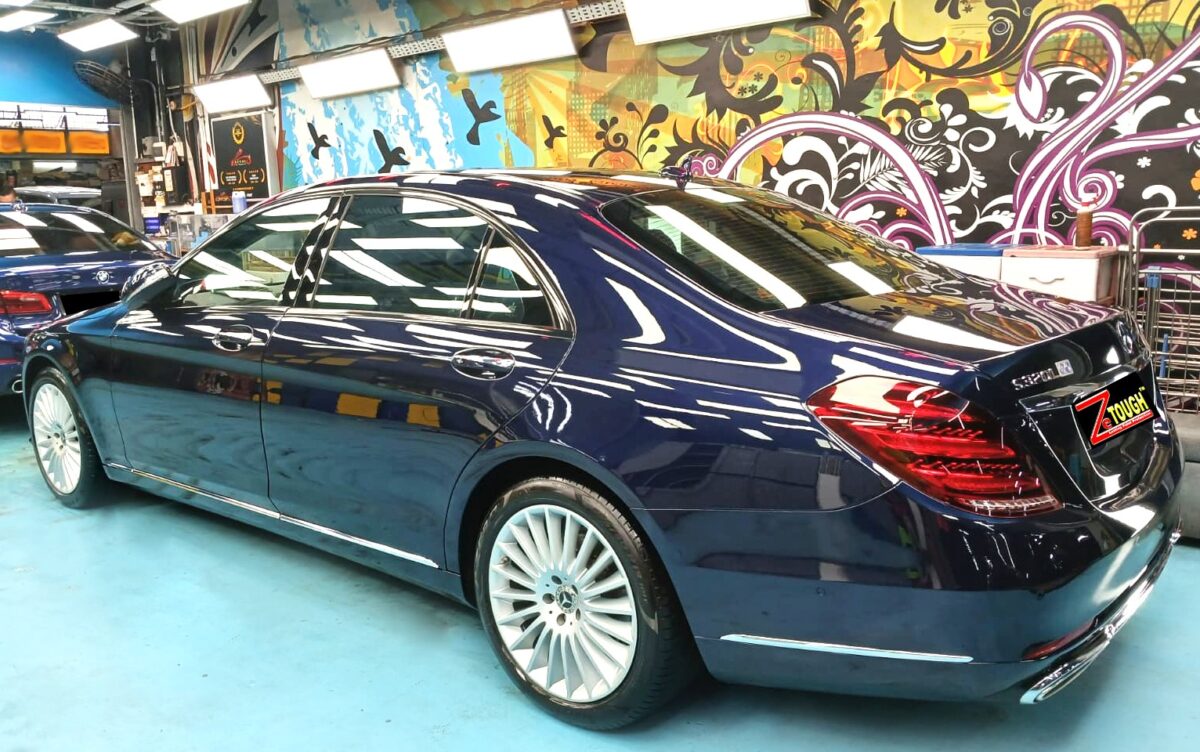 Rear quarter of the Mercedes-Benz S320L, glossy and protected.