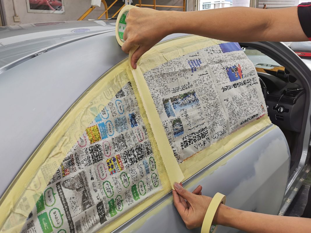 Non-painted surfaces being masked off on the S350L before spraying.