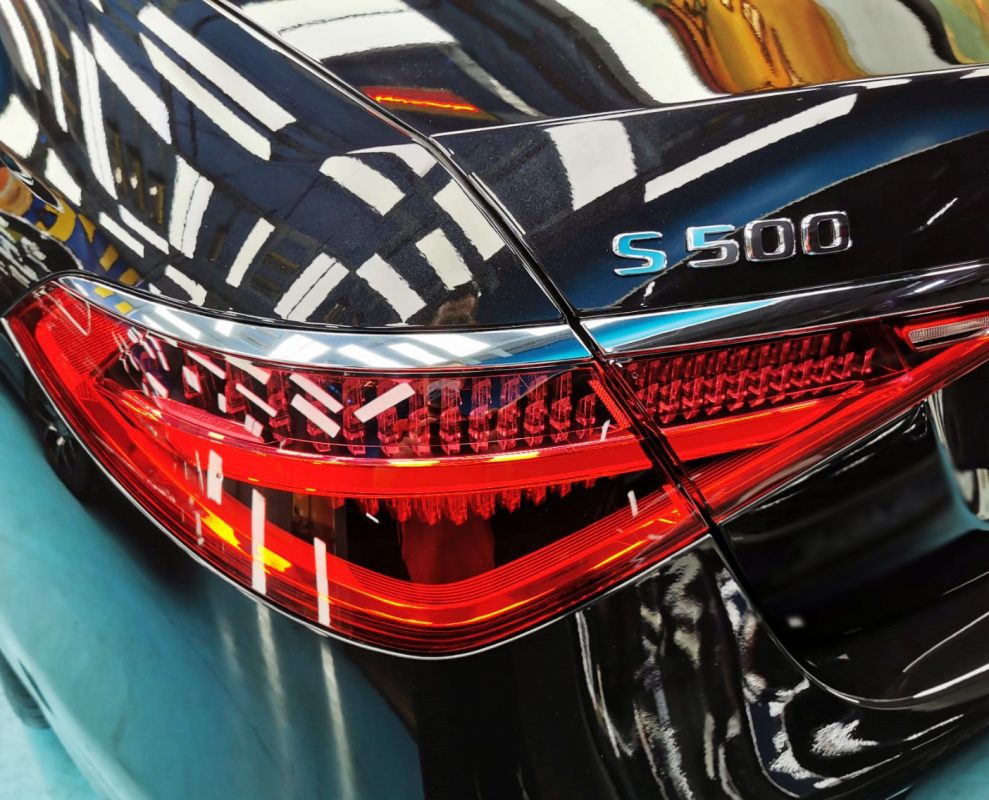 The coated bonnet of the S500L under workshop lighting.
