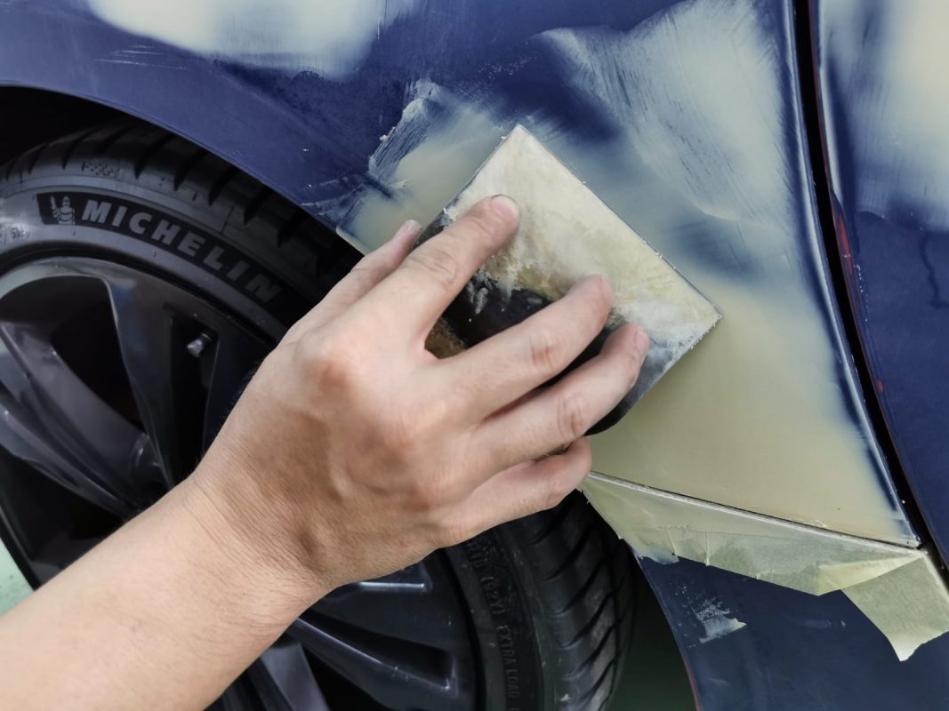 The SLK200's surface being checked for paintwork imperfections.