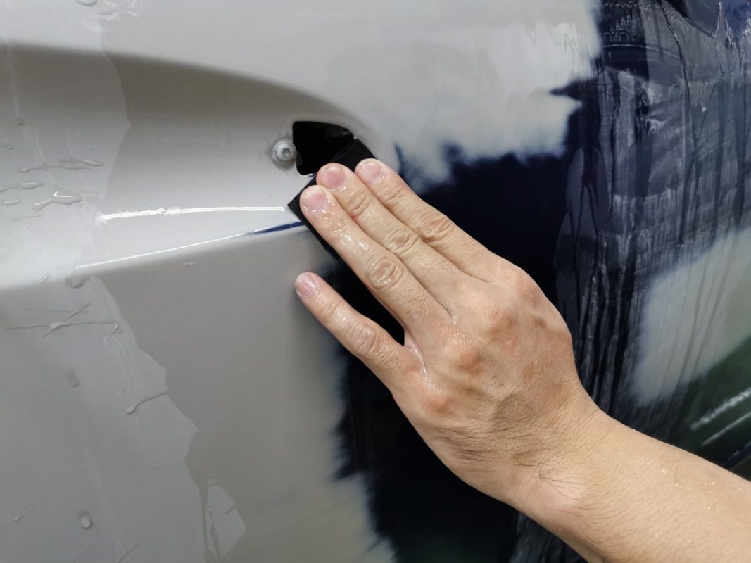 Wet-sanding the whole surface of the SLK200 to level the paintwork.