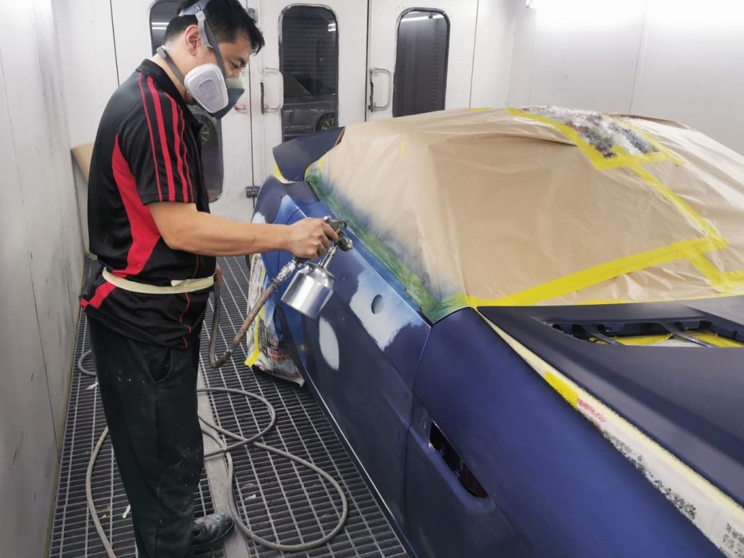The SLK200 being wet-sanded after spraying for an even surface.