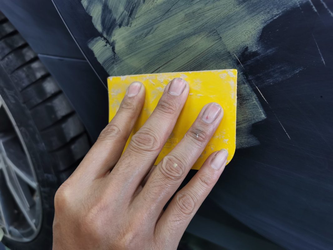 The car's surface inspected and patched where the paintwork was imperfect.