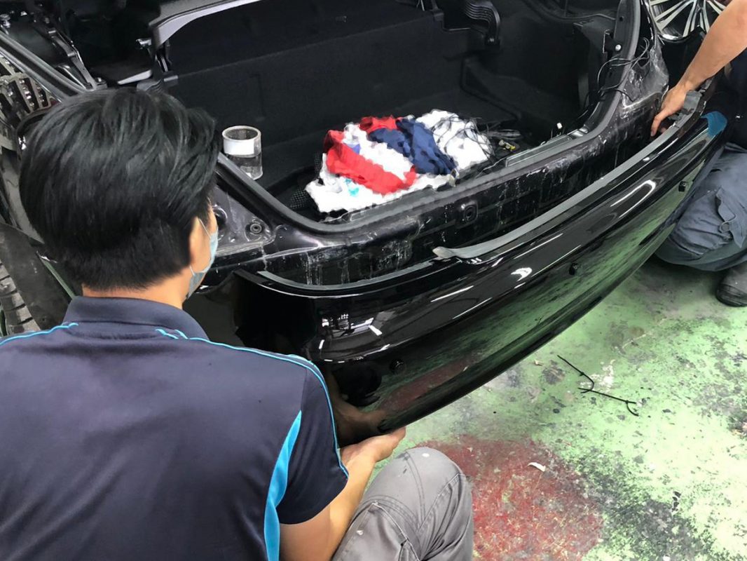 Previously removed car parts being refitted onto the SLK200.
