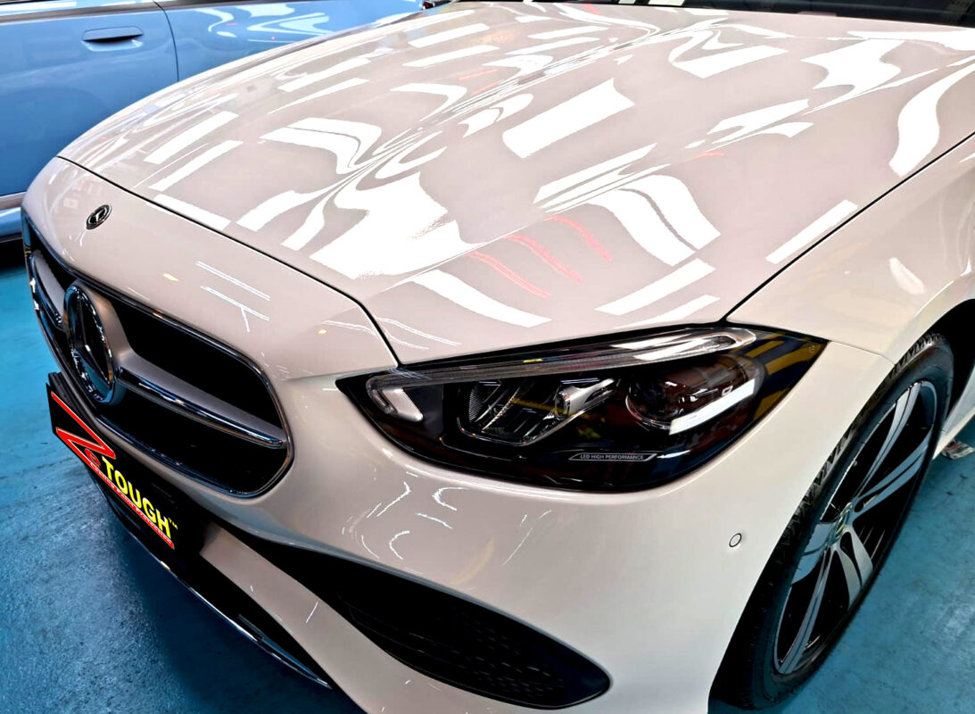 The Mercedes-Benz C180's coated paintwork under workshop lighting.