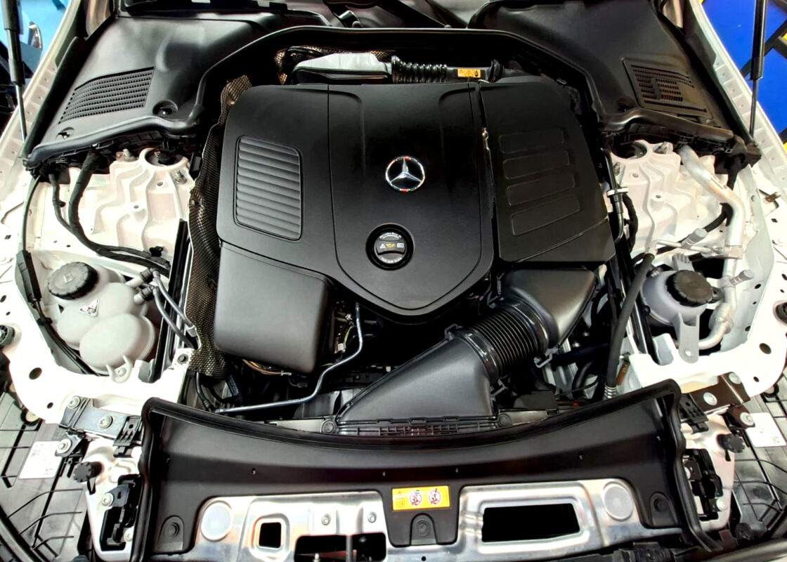 Reflections across the coated panels of the Mercedes-Benz C180.
