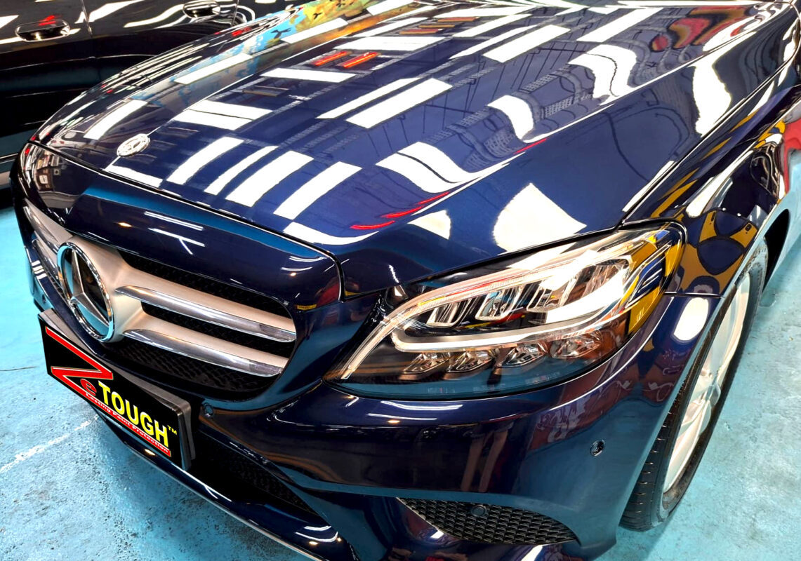 The Mercedes-Benz C180's coated paintwork under workshop lighting.