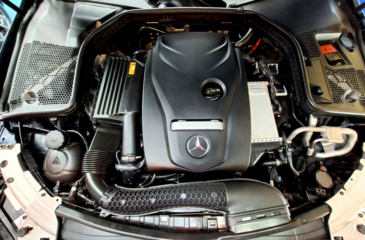 Reflections across the coated panels of the Mercedes-Benz C180.
