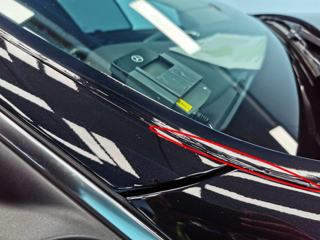 A chipped area on the C200's bodywork marked out for repair.
