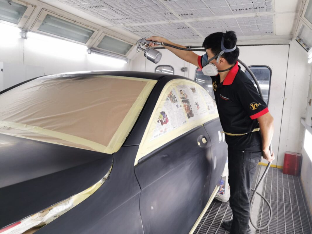 Masking paper taped over a panel on the C200 before the spray booth.